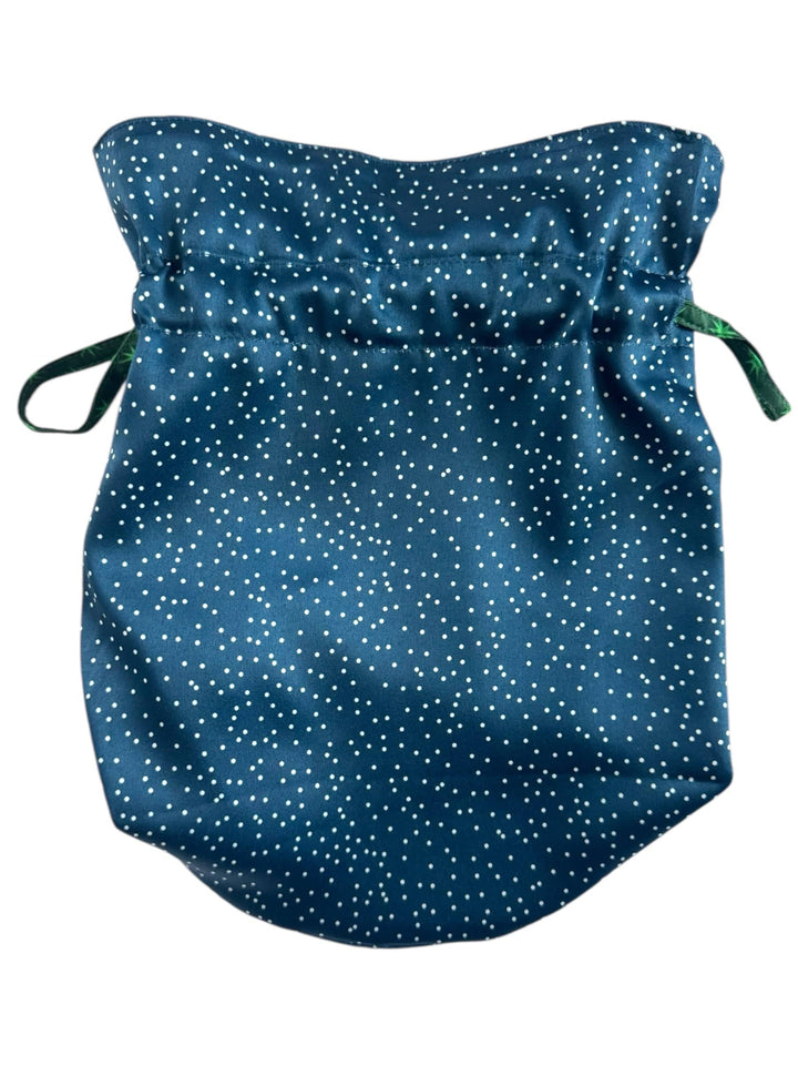 Blue fabric gift bag with white polka dots on a white background